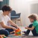 a man and a child playing with blocks on the floor